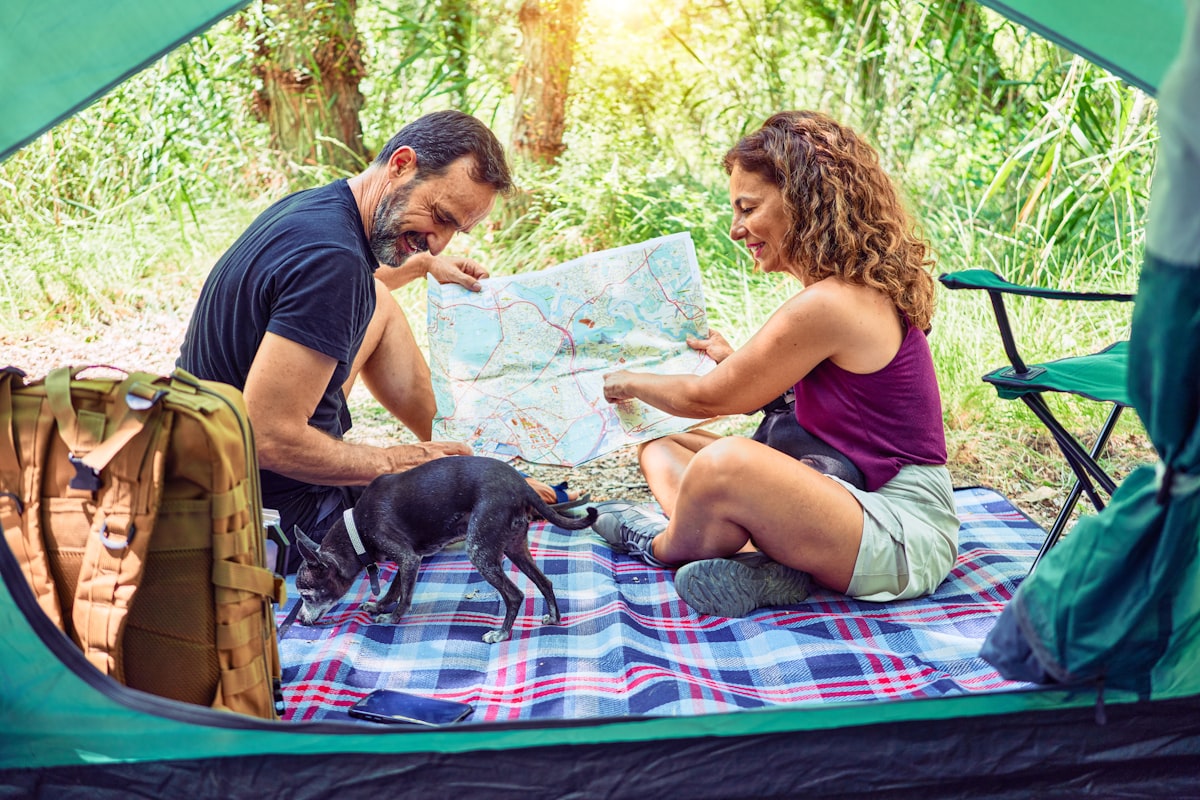Middle age couple  of hiker camping at the forest related to Find Your Perfect Outdoor Heating Solution: Chimineas for Sale