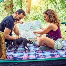 Middle age couple  of hiker camping at the forest related to Find Your Perfect Outdoor Heating Solution: Chimineas for Sale
