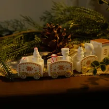 Miniature train decoration with pinecones and greenery related to All Aboard: Finding the Perfect Train Crib Bedding for Your Little One