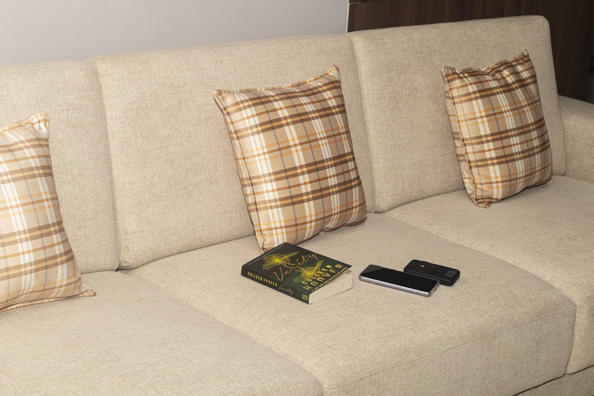 Mobile phone, power bank and book on the sofa related to Maximize Your Living Space with a Sleek Sofa Bed with Storage