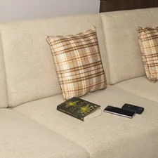 Mobile phone, power bank and book on the sofa related to Maximize Your Living Space with a Sleek Sofa Bed with Storage