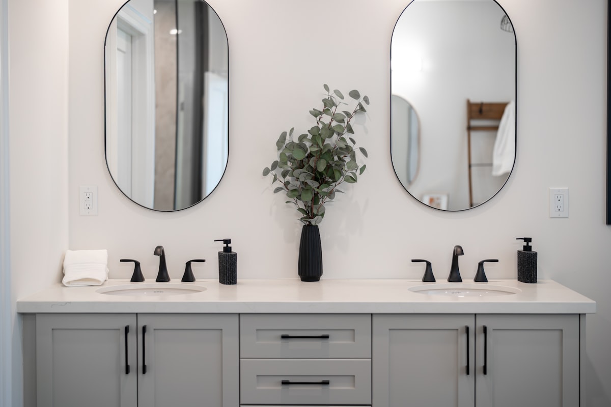 Modern bathroom vanity with double sinks and mirrors. related to Elevate Your Bathroom Style with Shower Curtains and Valances