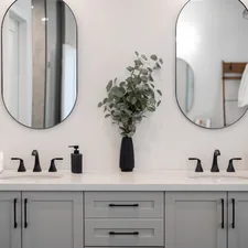 Modern bathroom vanity with double sinks and mirrors. related to Elevate Your Bathroom Style with Shower Curtains and Valances