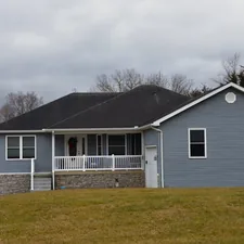 Modern blue/gray and white farmhouse with porch related to Charming Small Living Spaces