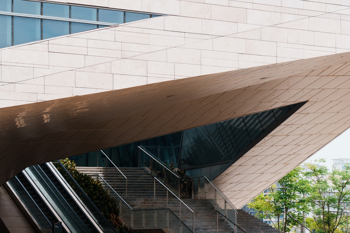 Modern building with angled architecture, escalators, and glass windows. related to Inspiring Front Entryway Design Ideas