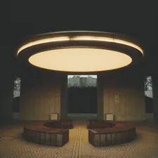 Modern circular seating area with overhead light related to Elevating Your Home's First Impression: A Guide to Entryway Ceiling Lights