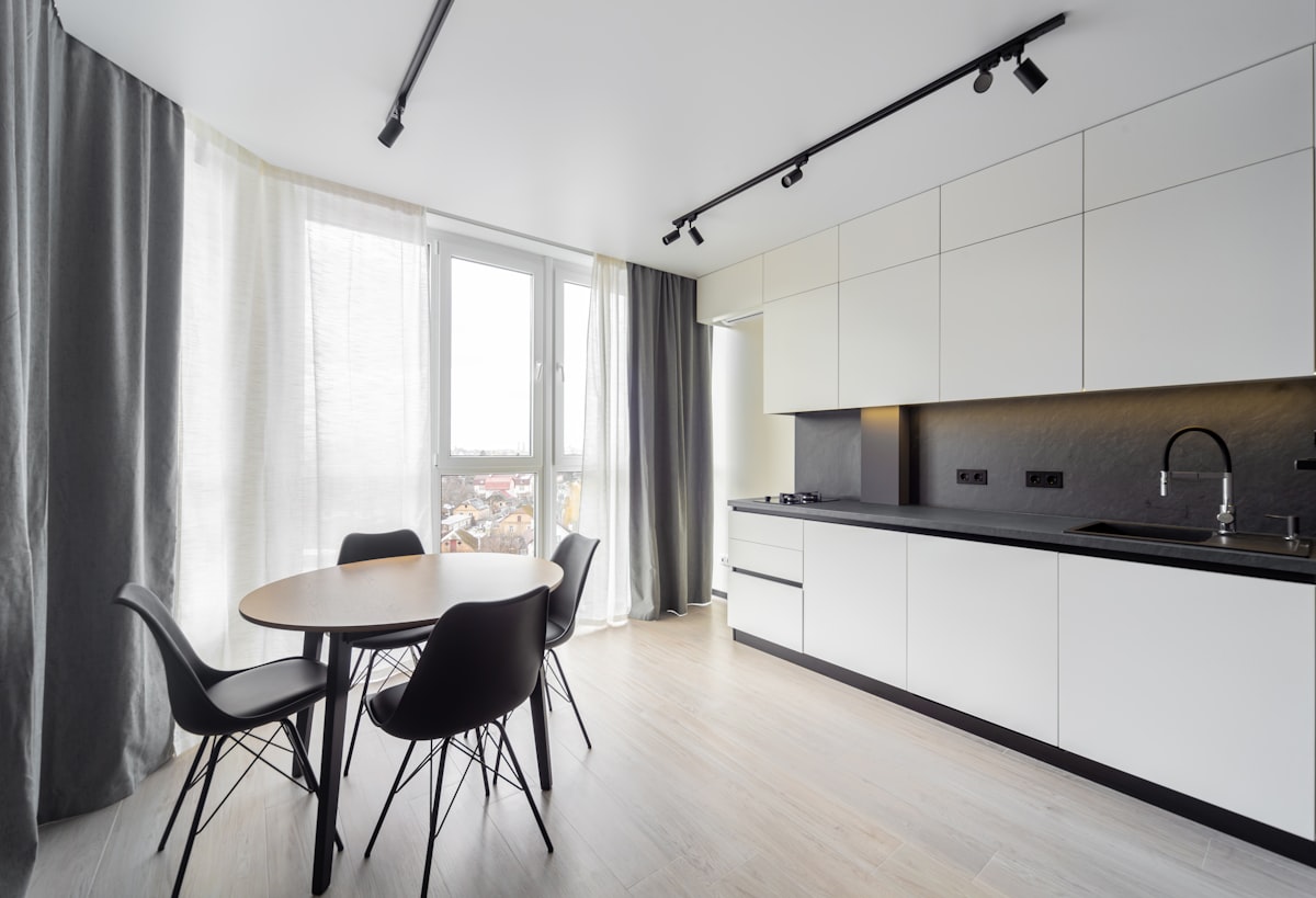 Modern kitchen with a dining area. related to Kitchen Curtain Valances: Elevate Your Kitchen Decor