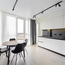 Modern kitchen with a dining area. related to Kitchen Curtain Valances: Elevate Your Kitchen Decor