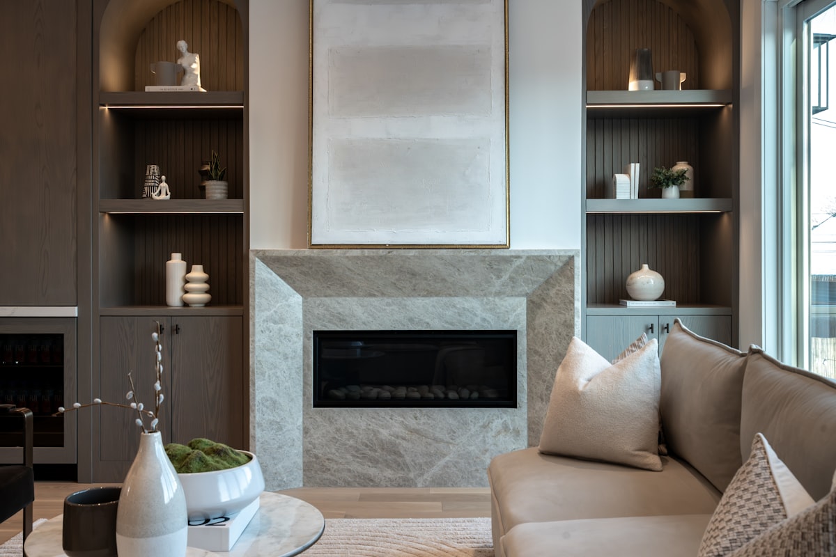 Modern living room with a fireplace and sofa. related to Elevate Your Home with Style: The Benefits of Window Wood Valance