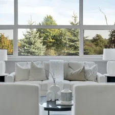 Modern living room with large window overlooking trees related to Valance Styles for Dressing Up Large Windows