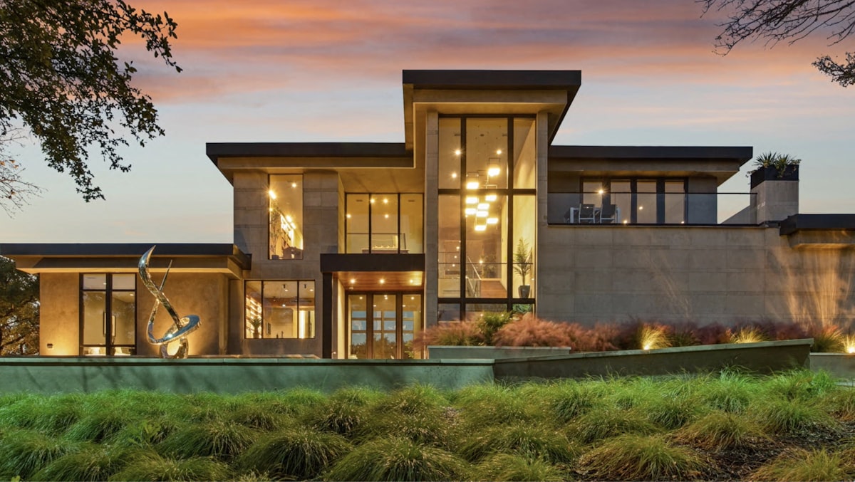 Modern luxury home with large windows at dusk related to Timeless Elegance: The Mission Style Sideboard