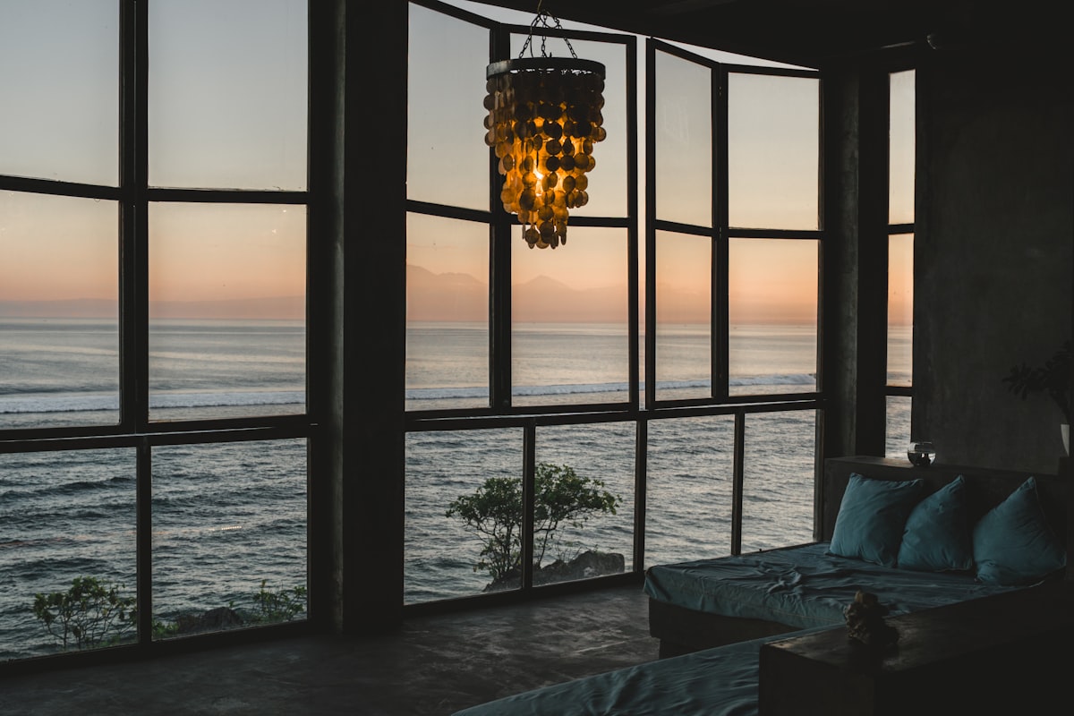 Modern room with ocean view at sunset related to The Modern Sofa Bed: Style and Space-Saving Innovation