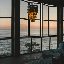 Modern room with ocean view at sunset related to The Modern Sofa Bed: Style and Space-Saving Innovation