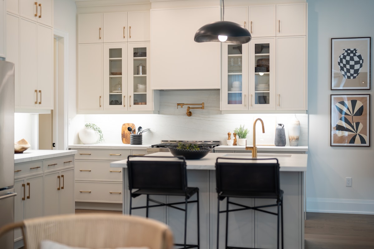 Modern white kitchen with island and bar stools related to Elevate Your Kitchen Style: The Ultimate Guide to Waverly Kitchen Valances
