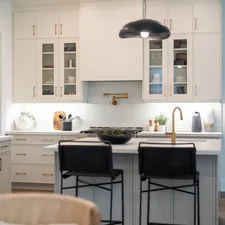 Modern white kitchen with island and bar stools related to Elevate Your Kitchen Style: The Ultimate Guide to Waverly Kitchen Valances