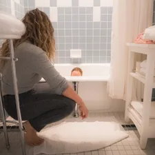 Mom bathing baby in bathtub. related to Maximizing Savings with Bed Bath & Beyond Printable Coupons