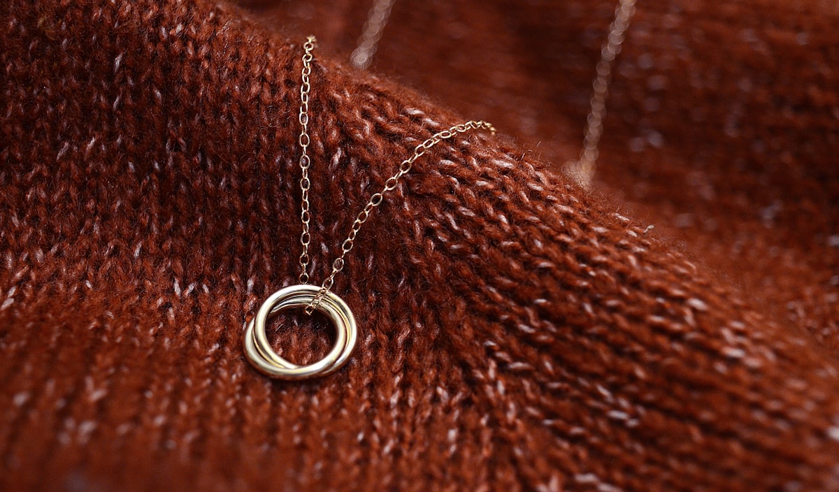 necklace on waves of fabric related to Cozying Up with Style: The Charm of Brown Quilted Coverlets