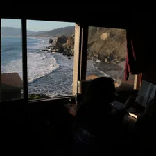 Ocean waves crash on a rocky coastline viewed from window related to Discover the Charm of Bed and Breakfasts in Eureka, CA