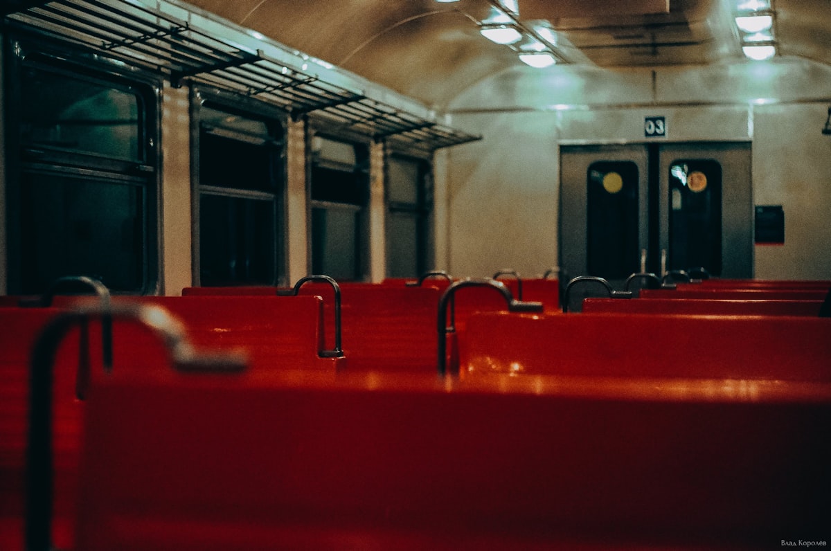 orange benches inside train related to Luxury and Comfort: Overnight Train Experiences