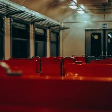 orange benches inside train related to Luxury and Comfort: Overnight Train Experiences