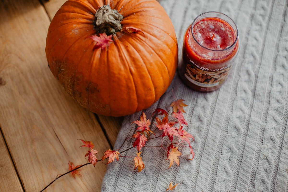 orange pumpkin on gray textile related to Snuggle Up This Christmas: Festive Bedding Ideas