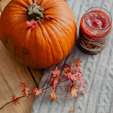 orange pumpkin on gray textile related to Snuggle Up This Christmas: Festive Bedding Ideas