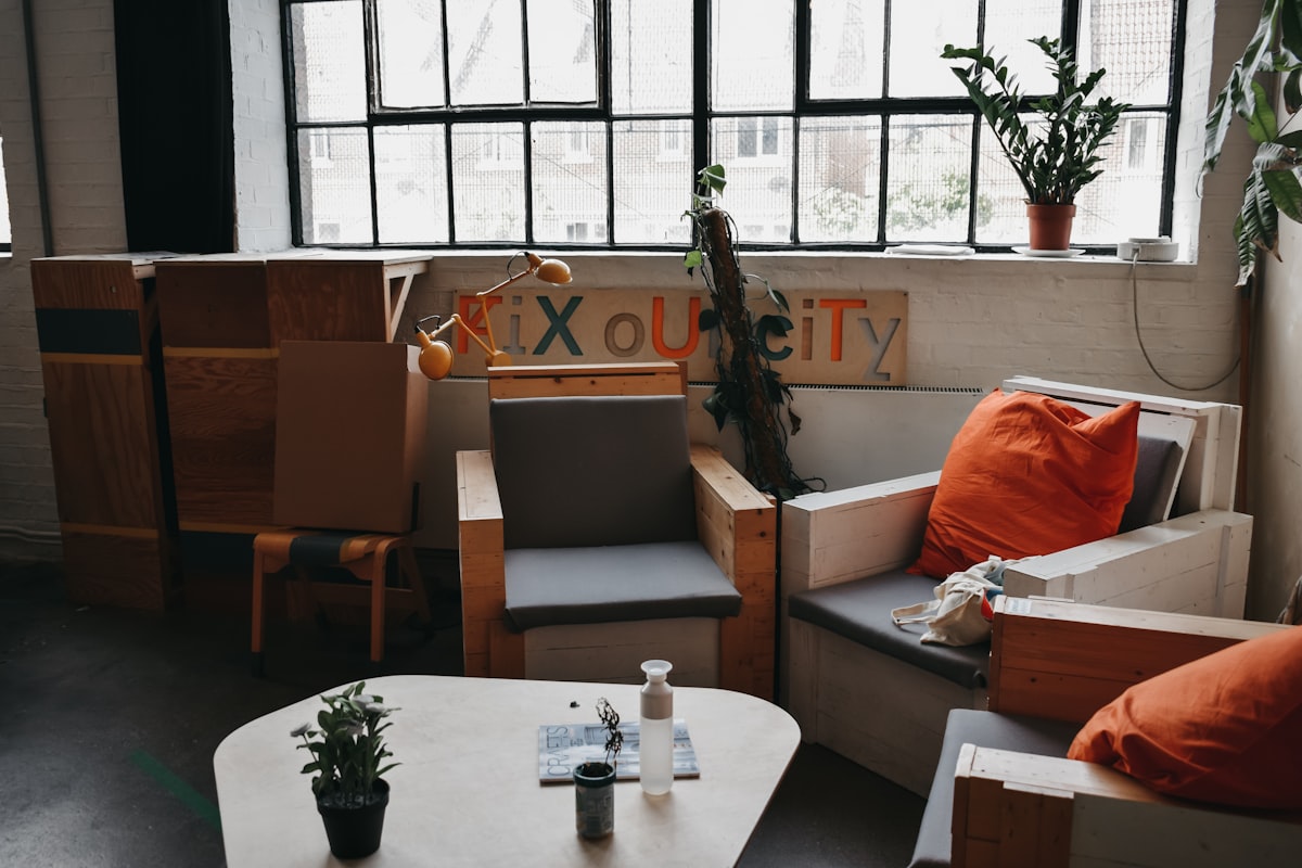 orange throw pillows on sofa armchairs near wooden wooden coffee table related to Elevate Your Space with the Waverly Williamsburg Valance: A Comprehensive Guide