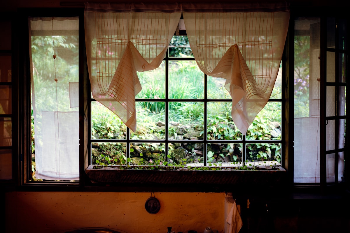 orange window curtains opened near brown wooden chair related to Kitchen Curtains and Valances