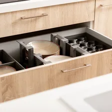 Organized kitchen drawer with plates, spices and cups in drawer organizers. related to Stylish Storage Solutions: Elevating Your Dining Space with a Red Sideboard Buffet