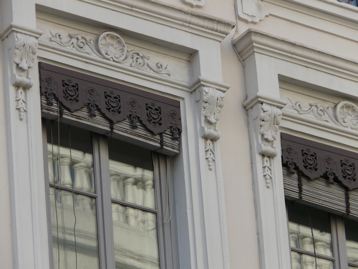 Ornate architectural detail on building windows. related to Elegant Waverly Valances and Swags: Enhance Your Windows with Class