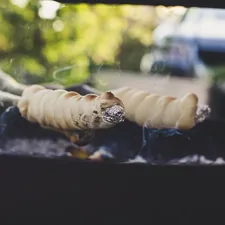 Outdoor grill & BBQ smoking stick bread related to Cooking on Chiminea: A Delicious Outdoor Experience