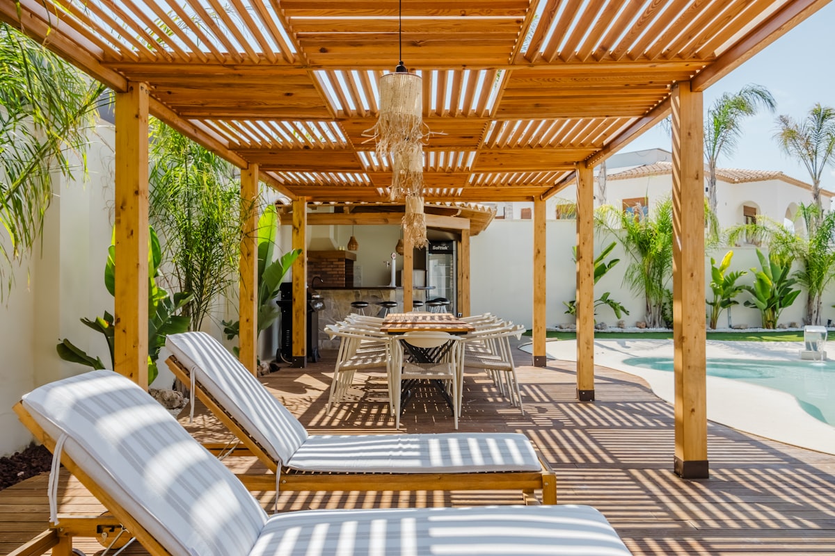 Outdoor patio with lounge chairs and dining table. related to Protect Your Outdoor Living Space with Chiminea Decking Protectors