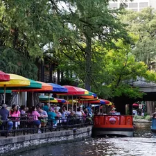 people riding on red boat on river during daytime related to Warm Up Your Nights with a Chiminea in San Antonio
