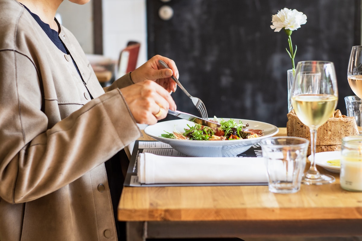 person eating vegetable salad related to Elevate Your Dining Experience: The Ultimate Guide to Sideboards & Buffets