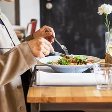 person eating vegetable salad related to Elevate Your Dining Experience: The Ultimate Guide to Sideboards & Buffets