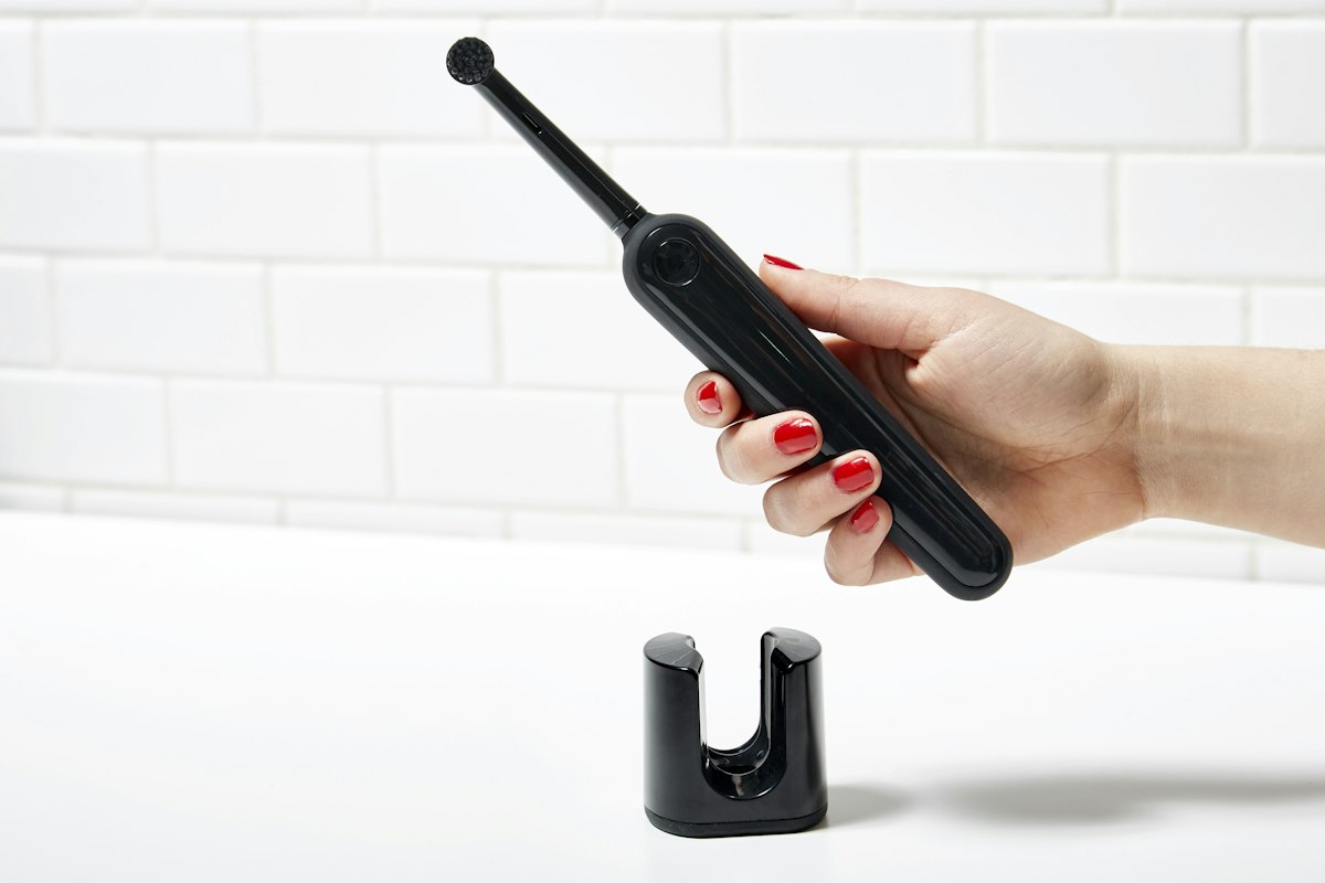 person holding black electronic device related to A Comprehensive Guide to Handheld Bidets