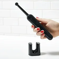 person holding black electronic device related to A Comprehensive Guide to Handheld Bidets