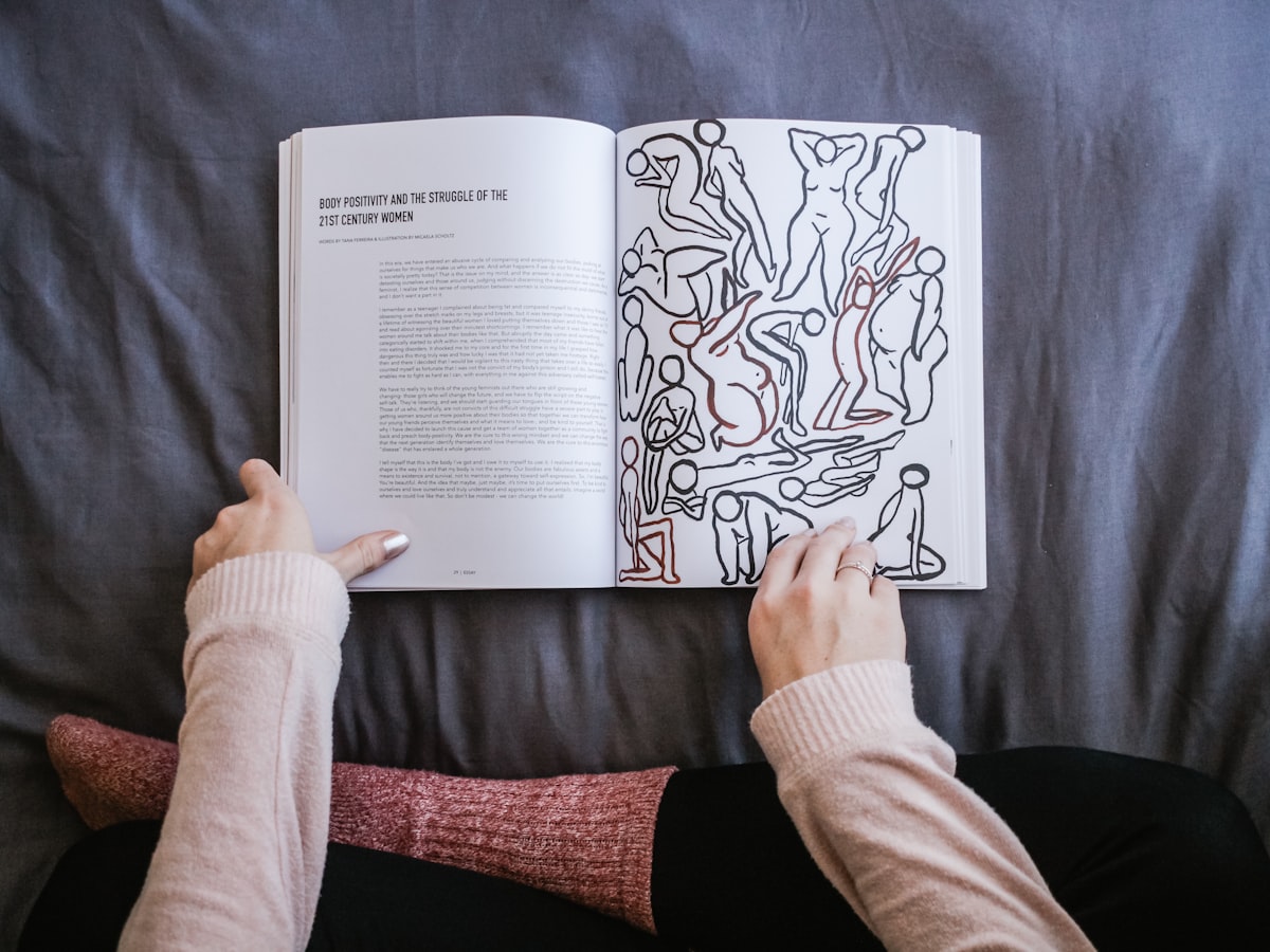 person holding book related to Discovering Comfort: The Ultimate Guide to Harry Barker Dog Beds