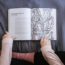 person holding book related to Discovering Comfort: The Ultimate Guide to Harry Barker Dog Beds
