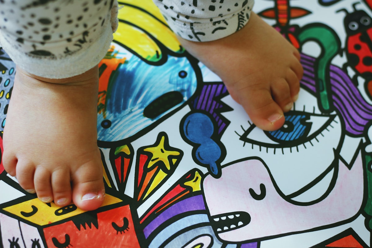 person holding white pink and blue floral textile related to Transform Your Toddler's Room with Superhero Bedding