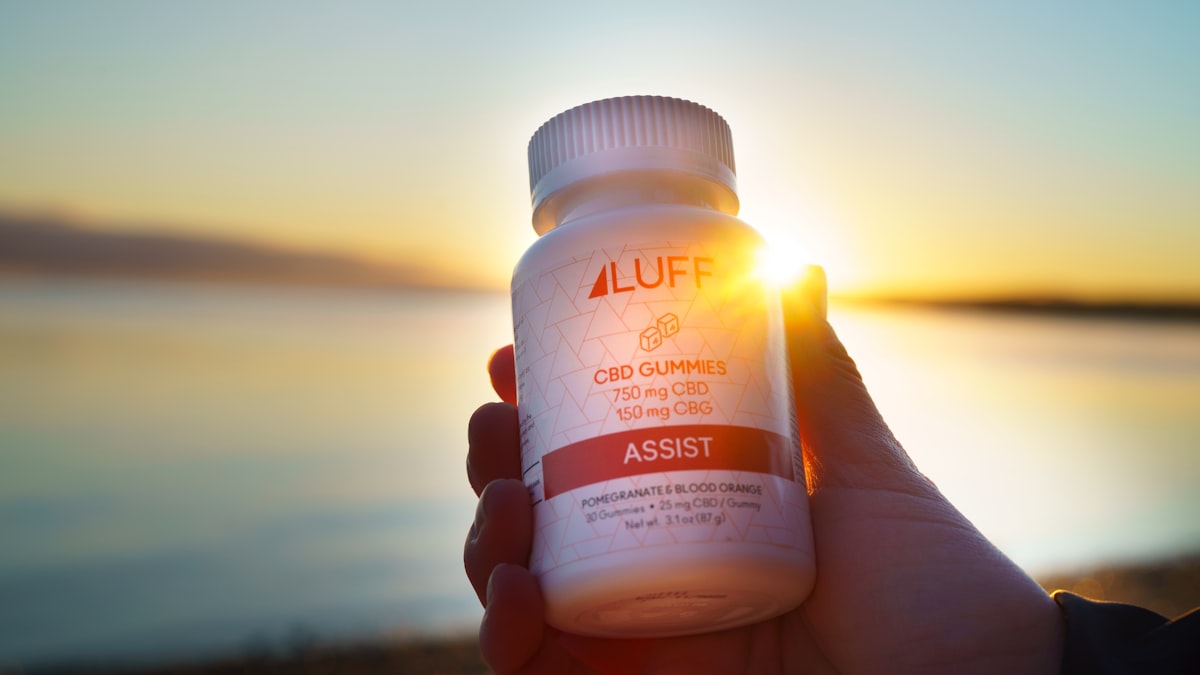 person holding white plastic bottle related to Unlocking the Benefits of L-Arginine Before Bed