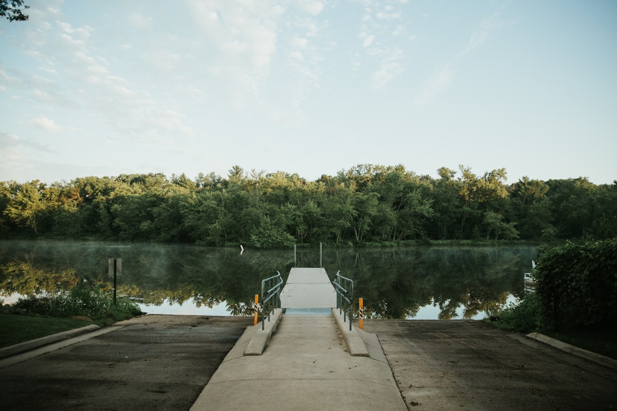 person in gray jacket standing on dock during daytime related to Top Wisconsin Dells Bed and Breakfasts for a Cozy Getaway
