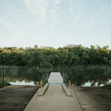 person in gray jacket standing on dock during daytime related to Top Wisconsin Dells Bed and Breakfasts for a Cozy Getaway