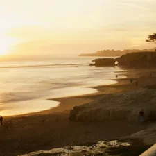 person walking on the seashore related to Discover the Charm of Santa Cruz: Top Bed and Breakfast Options