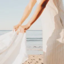 person wearing white dress during daytime related to Embracing Softness: A Guide to Choosing the Perfect Comforters and Coverlets