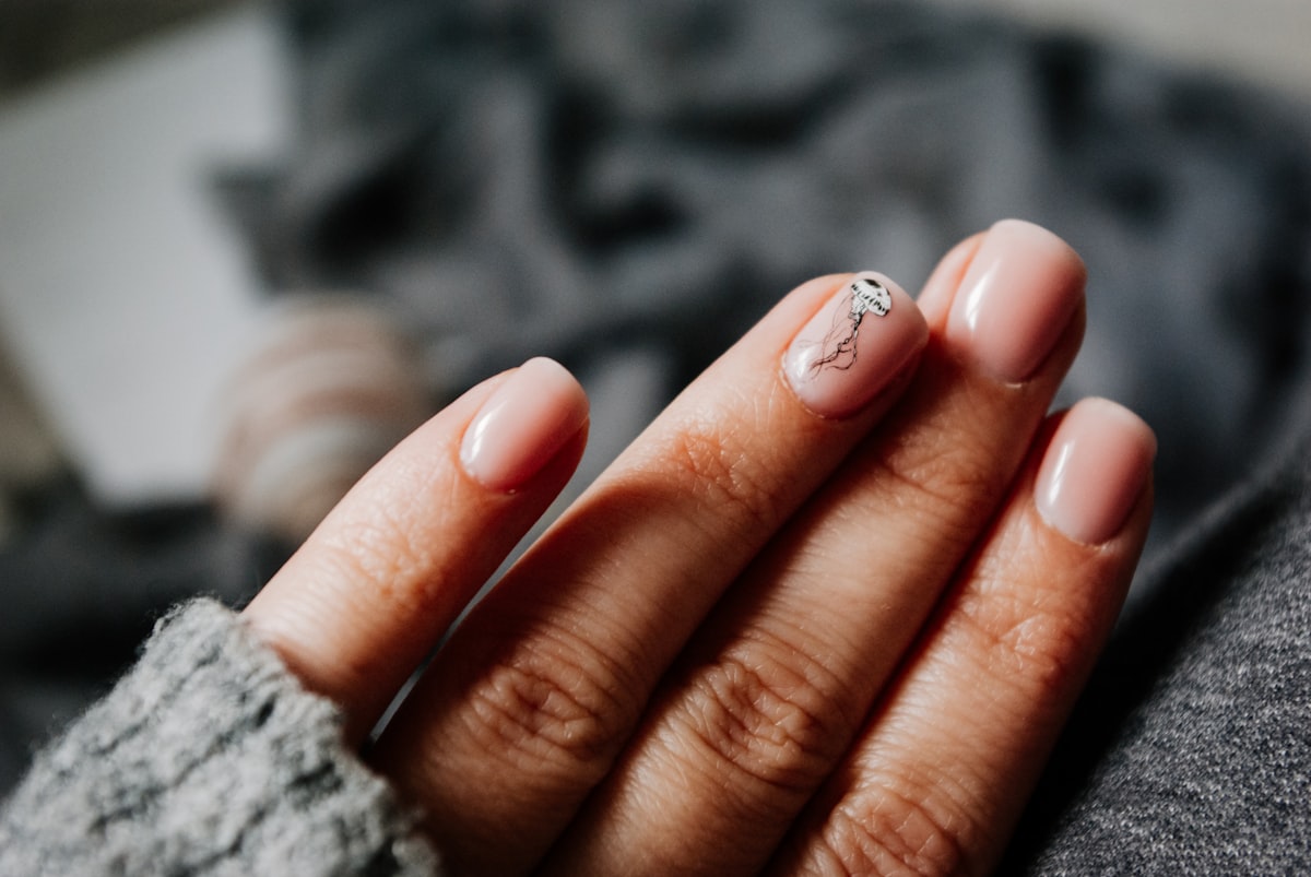 person with silver ring on finger related to Comprehensive Bed of Nails Reviews: Does It Really Work?
