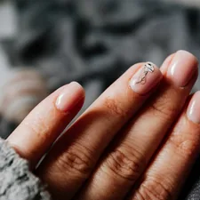 person with silver ring on finger related to Comprehensive Bed of Nails Reviews: Does It Really Work?