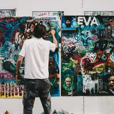Person working on painting related to Elevating Your Space: The Art of Balloon Valance Patterns