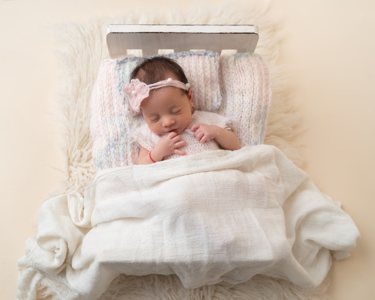 Photography of a newborn sleeping related to Cuddle Up: Essential Guide to Mini Crib Bedding Sets
