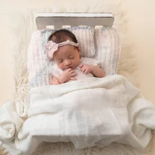 Photography of a newborn sleeping related to Cuddle Up: Essential Guide to Mini Crib Bedding Sets